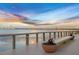 Scenic lakeside boardwalk with seating, offering peaceful sunset views at 43306 Water Bird Way # 6622, Punta Gorda, FL 33982