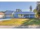 Bright yellow house with a metal roof and a spacious lawn at 4338 Shappell St, Port Charlotte, FL 33948