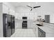 Modern kitchen with white cabinets, stainless steel appliances, and expansive countertops at 474 Orlando Blvd, Port Charlotte, FL 33954