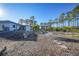 Landscaped backyard with stepping stones and a modern home at 489 & 497 Campbell St, Port Charlotte, FL 33953