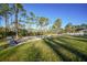 Landscaped backyard with a stone retaining wall and grassy area at 489 & 497 Campbell St, Port Charlotte, FL 33953