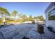 Landscaped backyard with gravel, hot tub, and natural surroundings at 489 & 497 Campbell St, Port Charlotte, FL 33953