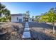 Home's backyard with stone pathway and tropical plants at 489 & 497 Campbell St, Port Charlotte, FL 33953