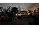 Night view of home's exterior, landscaping, and driveway at 489 & 497 Campbell St, Port Charlotte, FL 33953