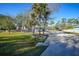 Landscaped yard with gravel driveway and palm trees at 489 & 497 Campbell St, Port Charlotte, FL 33953