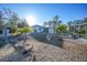 Backyard view of house with stone pathway and landscaping at 489 & 497 Campbell St, Port Charlotte, FL 33953