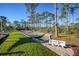 Pathway with a white bench, surrounded by grass and trees at 489 & 497 Campbell St, Port Charlotte, FL 33953