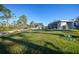 Large grassy yard with a modern home in the background at 489 & 497 Campbell St, Port Charlotte, FL 33953