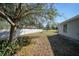 Large backyard with a tree providing shade and a partially visible fence at 4959 Cromey Rd, North Port, FL 34288