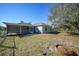 Spacious backyard with covered patio, fenced yard, and mature trees at 4959 Cromey Rd, North Port, FL 34288