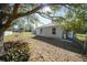 Yard with mature tree, providing shade, and a partially visible fence at 4959 Cromey Rd, North Port, FL 34288