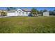 Single-story home with a grassy yard and attached garage at 4959 Cromey Rd, North Port, FL 34288