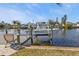 Private boat dock with lift and seating area, perfect for enjoying water views at 498 E Tarpon Nw Blvd, Port Charlotte, FL 33952