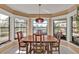 Sunlit dining room with large windows and mid-century table at 498 E Tarpon Nw Blvd, Port Charlotte, FL 33952