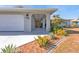 House entrance with covered walkway and tropical landscaping at 498 E Tarpon Nw Blvd, Port Charlotte, FL 33952