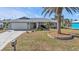 Single-story home with attached garage and palm tree landscaping at 498 E Tarpon Nw Blvd, Port Charlotte, FL 33952