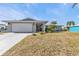 Single story home with attached garage and manicured lawn at 498 E Tarpon Nw Blvd, Port Charlotte, FL 33952