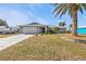 Single story home with attached garage and manicured lawn at 498 E Tarpon Nw Blvd, Port Charlotte, FL 33952