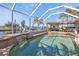 Relaxing pool area with water feature and patio furniture at 498 E Tarpon Nw Blvd, Port Charlotte, FL 33952