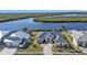 Aerial view of waterfront home with private dock and lush landscaping at 5189 Collingswood Blvd, Port Charlotte, FL 33948