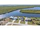 Three homes on a waterfront lot with mature landscaping at 5189 Collingswood Blvd, Port Charlotte, FL 33948