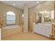 Elegant bathroom with a large soaking tub, double vanity, and glass shower at 5189 Collingswood Blvd, Port Charlotte, FL 33948