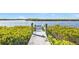 Private wooden dock extending over calm waters at 5189 Collingswood Blvd, Port Charlotte, FL 33948