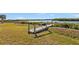 Wooden dock extending into calm waters at 5189 Collingswood Blvd, Port Charlotte, FL 33948