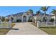 Single-story home with metal roof and white picket fence at 5189 Collingswood Blvd, Port Charlotte, FL 33948