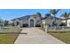 House exterior featuring a metal roof, double doors, and a long driveway at 5189 Collingswood Blvd, Port Charlotte, FL 33948