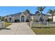 House exterior featuring a metal roof, double doors, and a long driveway at 5189 Collingswood Blvd, Port Charlotte, FL 33948