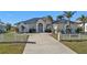 Single-story home with metal roof and white picket fence at 5189 Collingswood Blvd, Port Charlotte, FL 33948