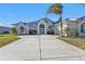 Spacious home with a large driveway and landscaping at 5189 Collingswood Blvd, Port Charlotte, FL 33948