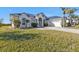 Beautiful one-story home with a metal roof and lush lawn at 5189 Collingswood Blvd, Port Charlotte, FL 33948