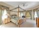 Large bedroom with a four-poster bed and ample natural light at 5189 Collingswood Blvd, Port Charlotte, FL 33948