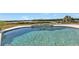 Inviting kidney-shaped pool with spa and water view at 5189 Collingswood Blvd, Port Charlotte, FL 33948