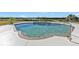 Inviting kidney-shaped pool with spa and water view at 5189 Collingswood Blvd, Port Charlotte, FL 33948