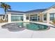 Relaxing kidney-shaped pool and spa at 5189 Collingswood Blvd, Port Charlotte, FL 33948