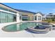 Inviting kidney-shaped pool with adjacent spa at 5189 Collingswood Blvd, Port Charlotte, FL 33948