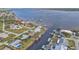 Aerial view of waterfront properties featuring private docks along a canal with scenic bay vistas at 5194 Fleming St, Port Charlotte, FL 33981