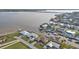 Aerial view of waterfront homes with private docks along a scenic canal leading to a large bay at 5194 Fleming St, Port Charlotte, FL 33981