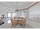 Bright dining area features tile floors, a glass table and chairs with pink cushions, plus natural light from large windows at 5194 Fleming St, Port Charlotte, FL 33981