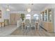 Bright dining room featuring wood floors, light colored walls, and decorative light fixture at 5194 Fleming St, Port Charlotte, FL 33981