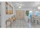 Bright foyer featuring tile floors, a decorative mirror, and views into the dining area at 5194 Fleming St, Port Charlotte, FL 33981