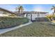 Close up of the home's front entrance, landscaping, and walkway at 5194 Fleming St, Port Charlotte, FL 33981