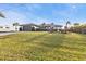 Well-kept lawn fronts this single-story home with a two-car garage and flowering bushes at 5194 Fleming St, Port Charlotte, FL 33981