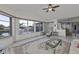 Bright living room with tile flooring, comfortable white sofa, and views of the water from the large windows at 5194 Fleming St, Port Charlotte, FL 33981