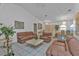 Bright living room featuring white tile flooring, light colored walls, and leather furniture at 5194 Fleming St, Port Charlotte, FL 33981