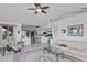 Spacious living room with tile floors, white sofa, and open layout leading to the kitchen and dining areas at 5194 Fleming St, Port Charlotte, FL 33981