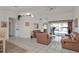 Bright living room featuring white tile flooring, light colored walls, and leather furniture at 5194 Fleming St, Port Charlotte, FL 33981